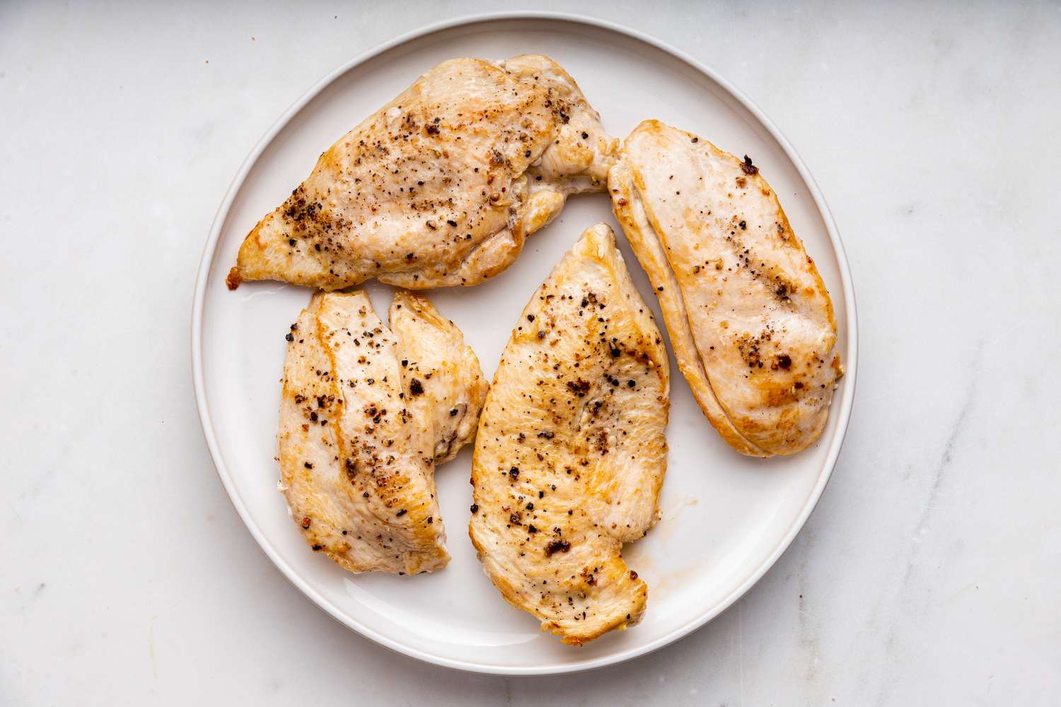 cooked chicken resting on a plate for easy chicken primavera recipe