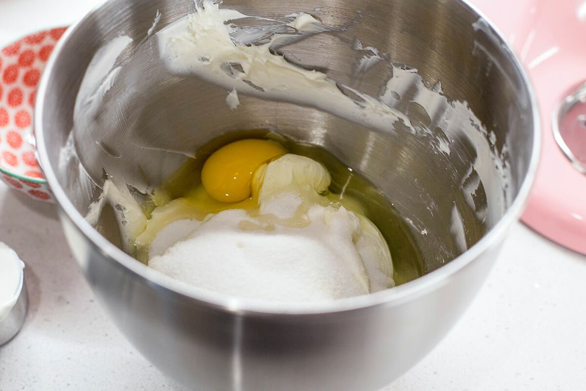 Cheesecake Bars with Cookie Crust beat in the eggs and sugar 