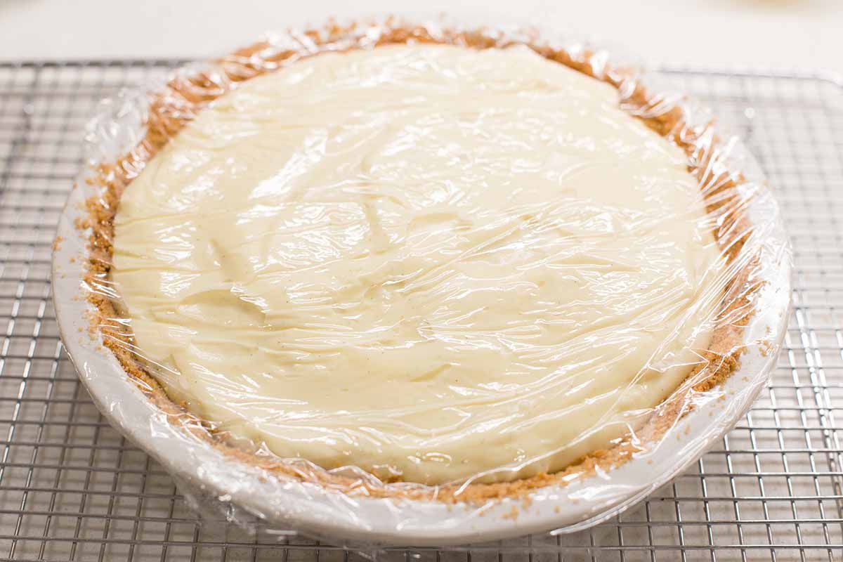Banana cream pie with clingflim over the top.