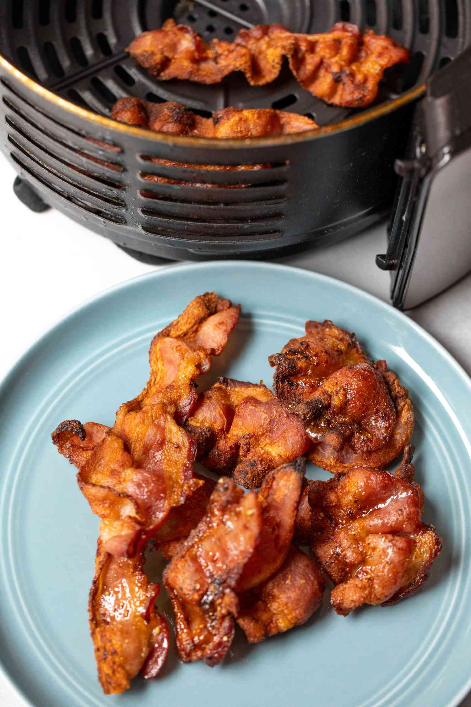 Air Fryer Bacon on Plate and in Air Fryer