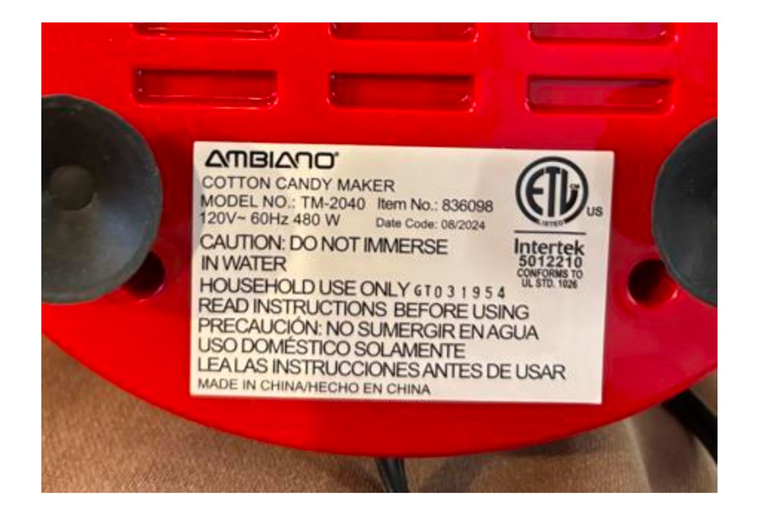 Label on the base of a cotton candy maker detailing model safety instructions and electrical ratings