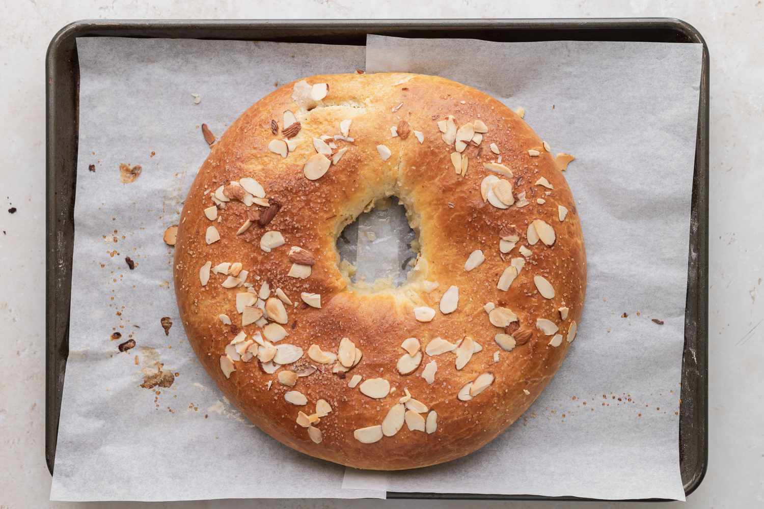 Overhead view of a Danish kringle on parchment covered baking sheet.