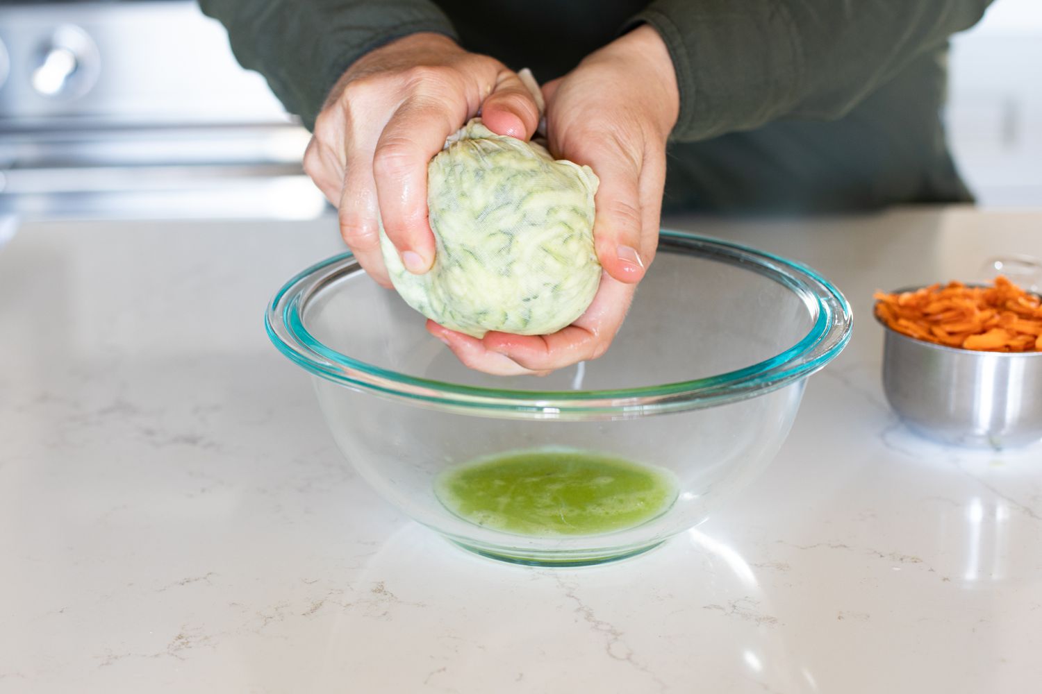 Water Squeezed Out from Zucchini in Cheese Cloth for Zucchini and Carrot Bread