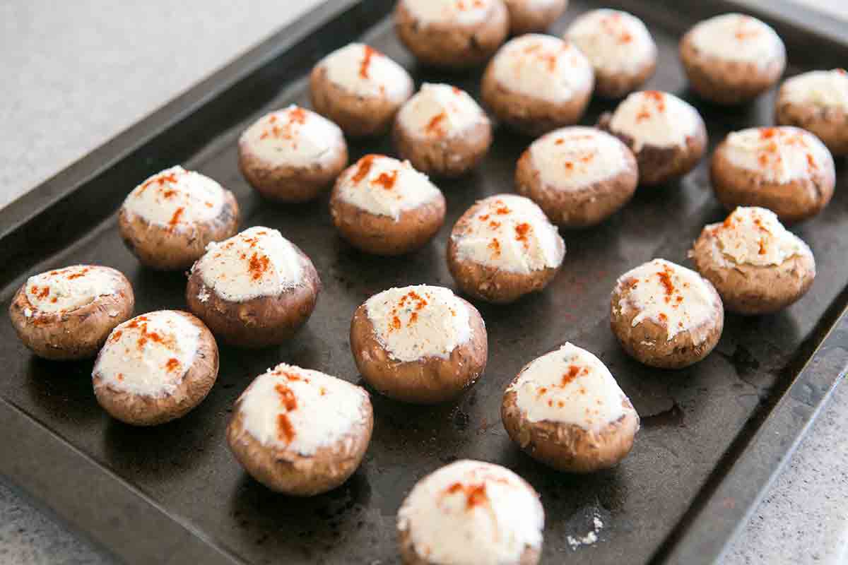 stuffed mushrooms on baking sheet