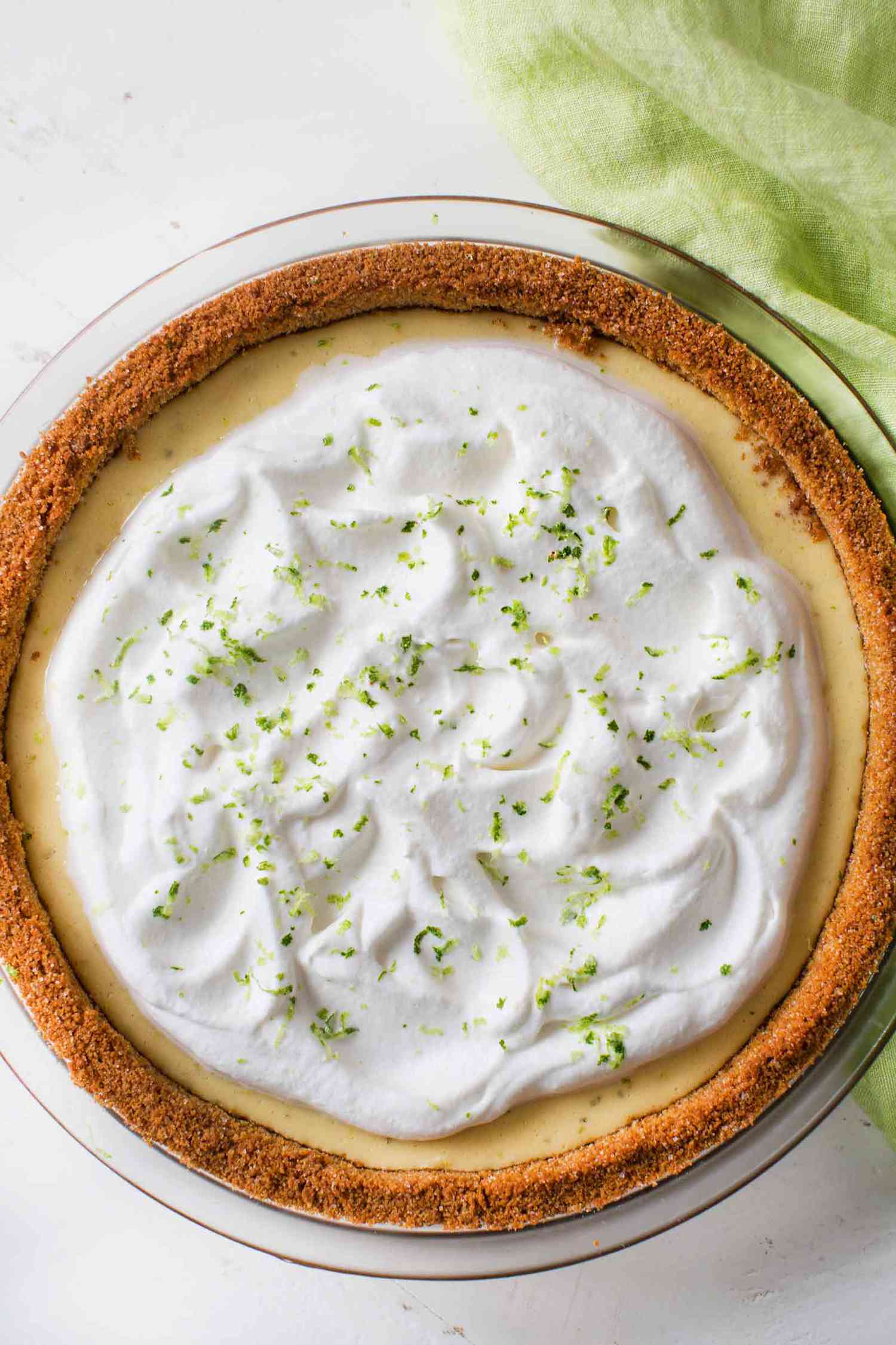 Key Lime Pie topped with whipped cream and lime zest