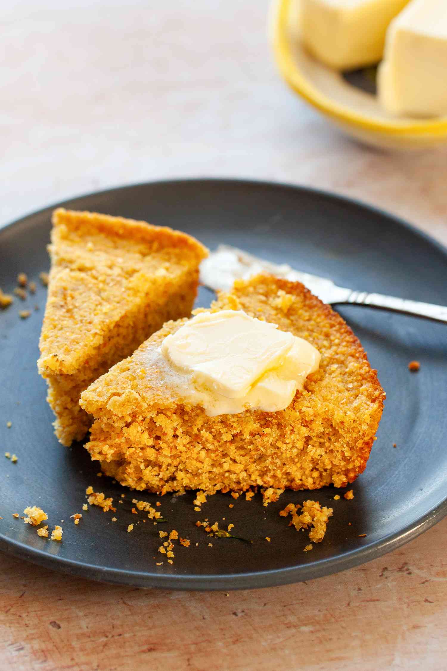 Plate with Two Slices of Southern Cornbread Covered in Some Butter 