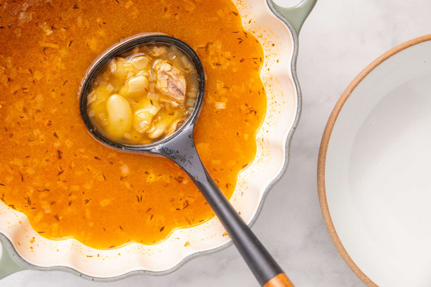 15-Minute Tuna and Butter Bean Stew in a large bowl with a ladle