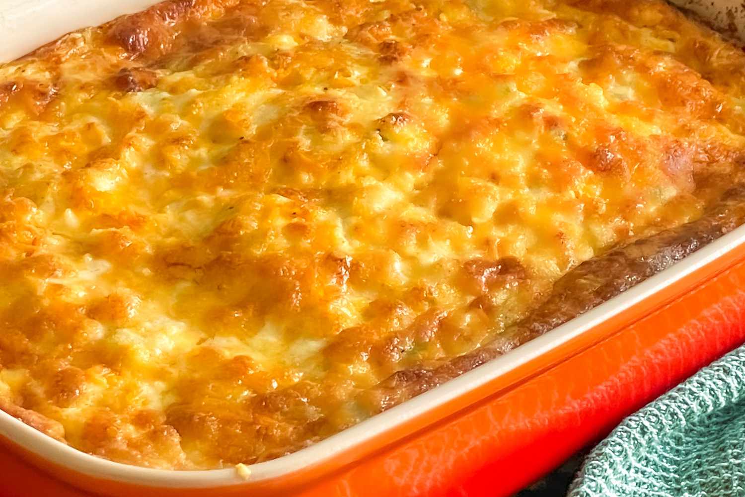Angled view of an orange casserole dish of Chile Cheese Egg Casserole