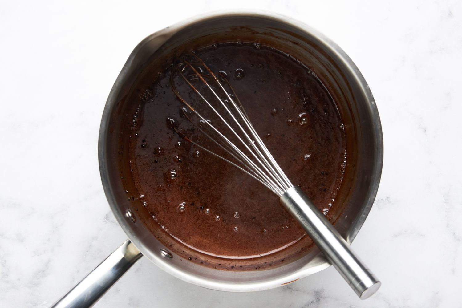 Hot fudge sauce base whisked together in a saucepan