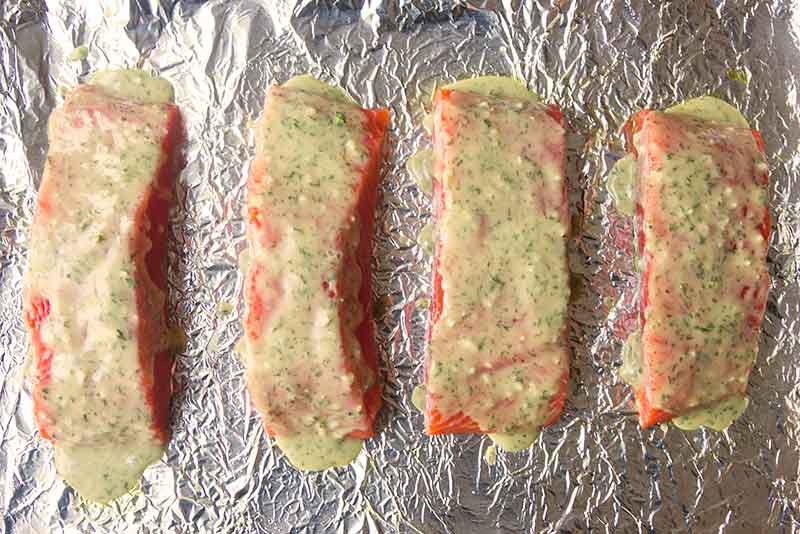 raw salmon with honey mustard on the sheet pan