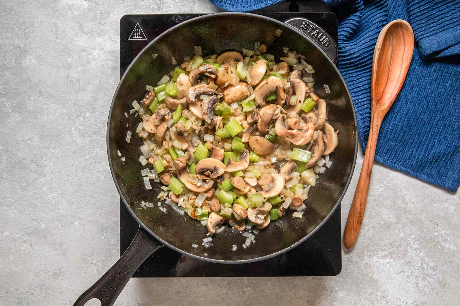 Mushrooms added to cast iron skillet with the sauteed aromatics for chicken a la king recipe