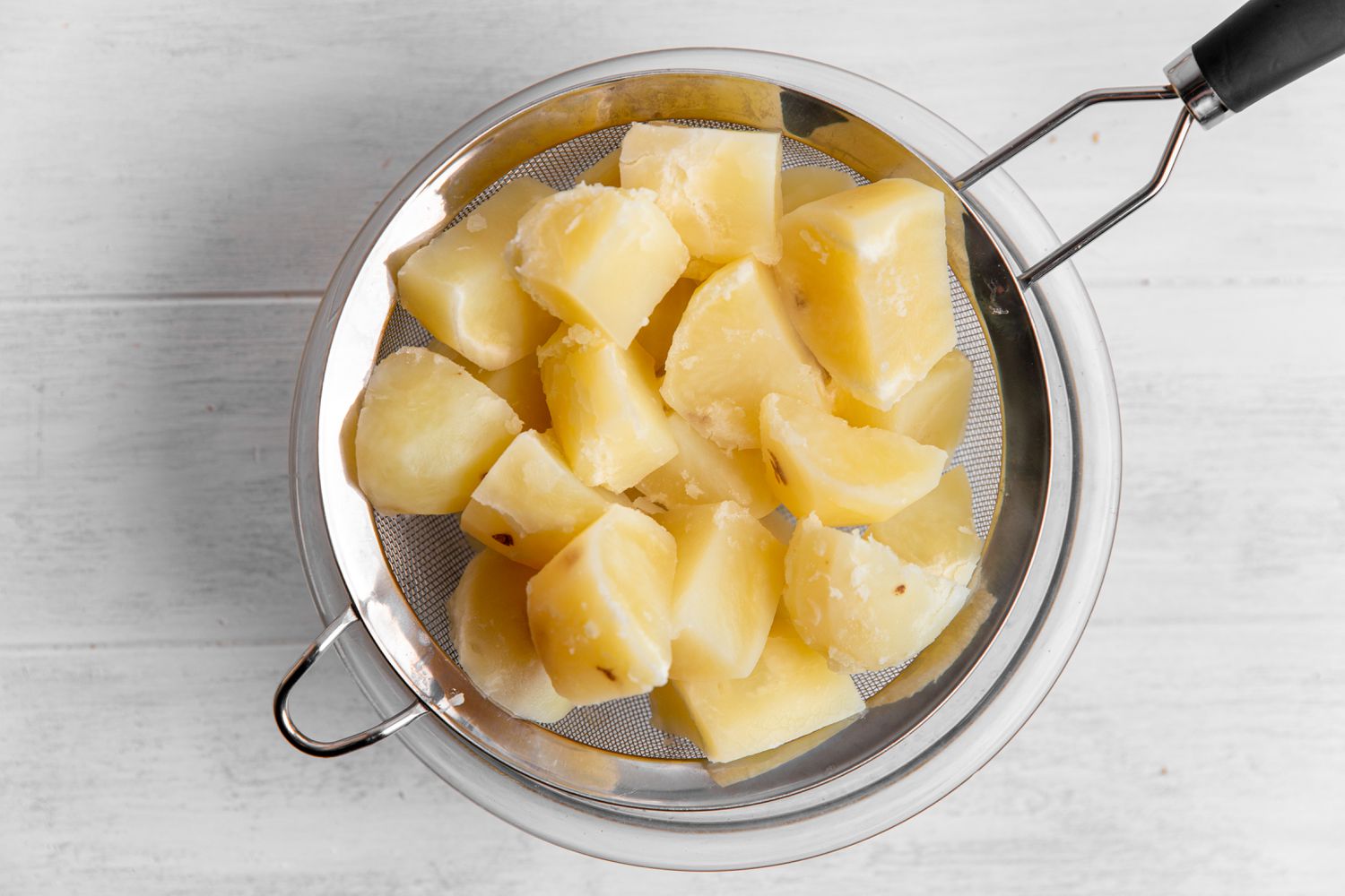 Boiled and Skinned Potatoes in a Colander for Mashed Potatoes Recipe
