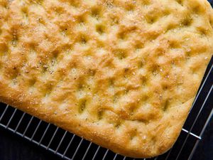 Easy focaccia bread with rosemary baked and cooling on a cooling rack