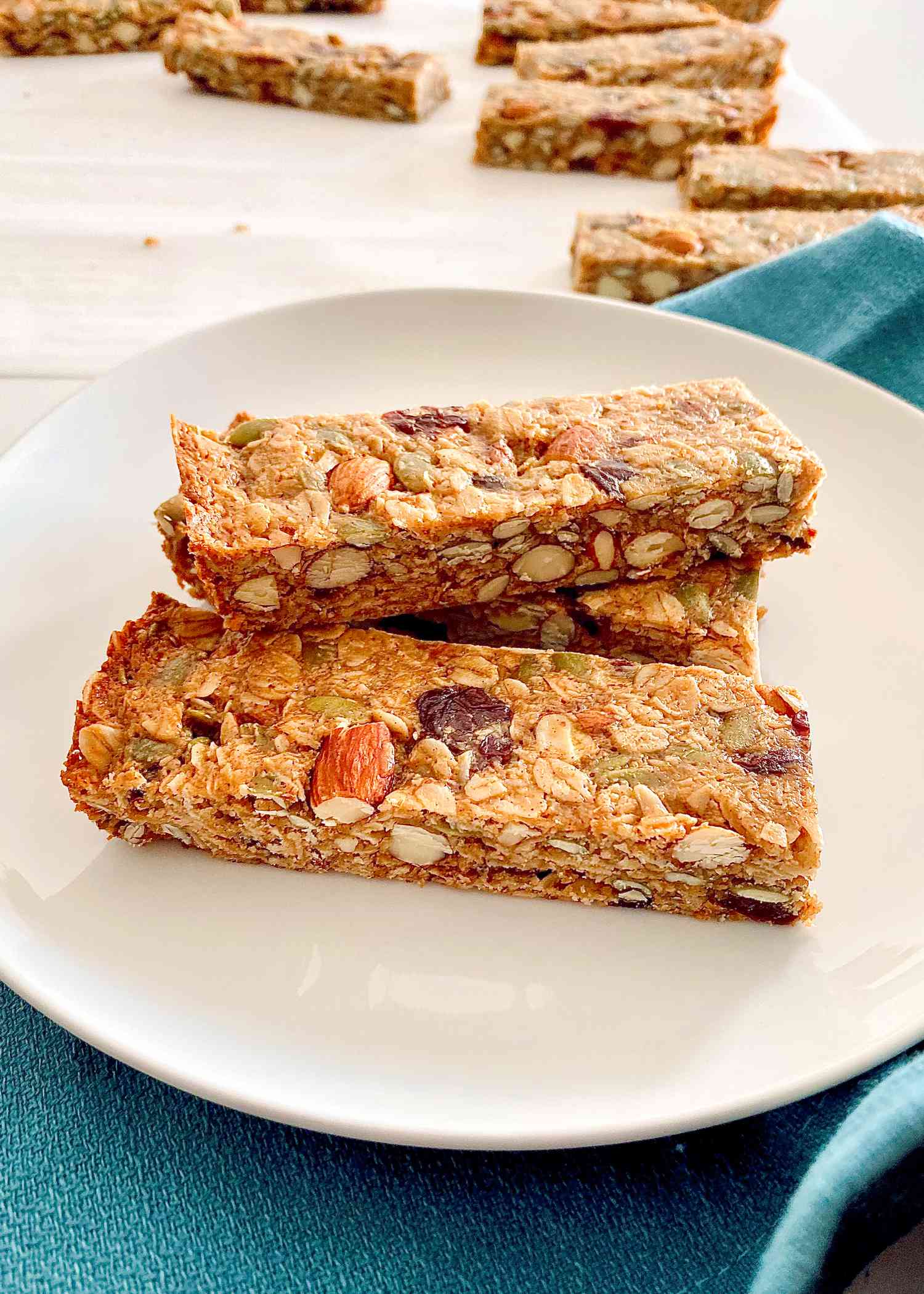 Chewy Fruit and Nut Granola Bars stacked on a plate.