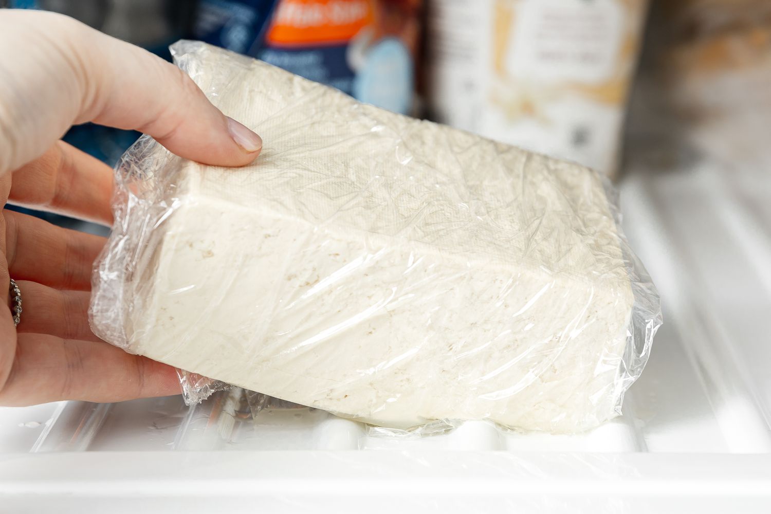 Plastic Wrapped Block of Tofu Placed in the Freezer for Copycat Sofritas Recipe