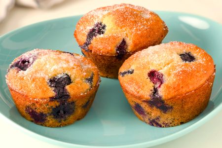 3 blueberry muffins on a small plate