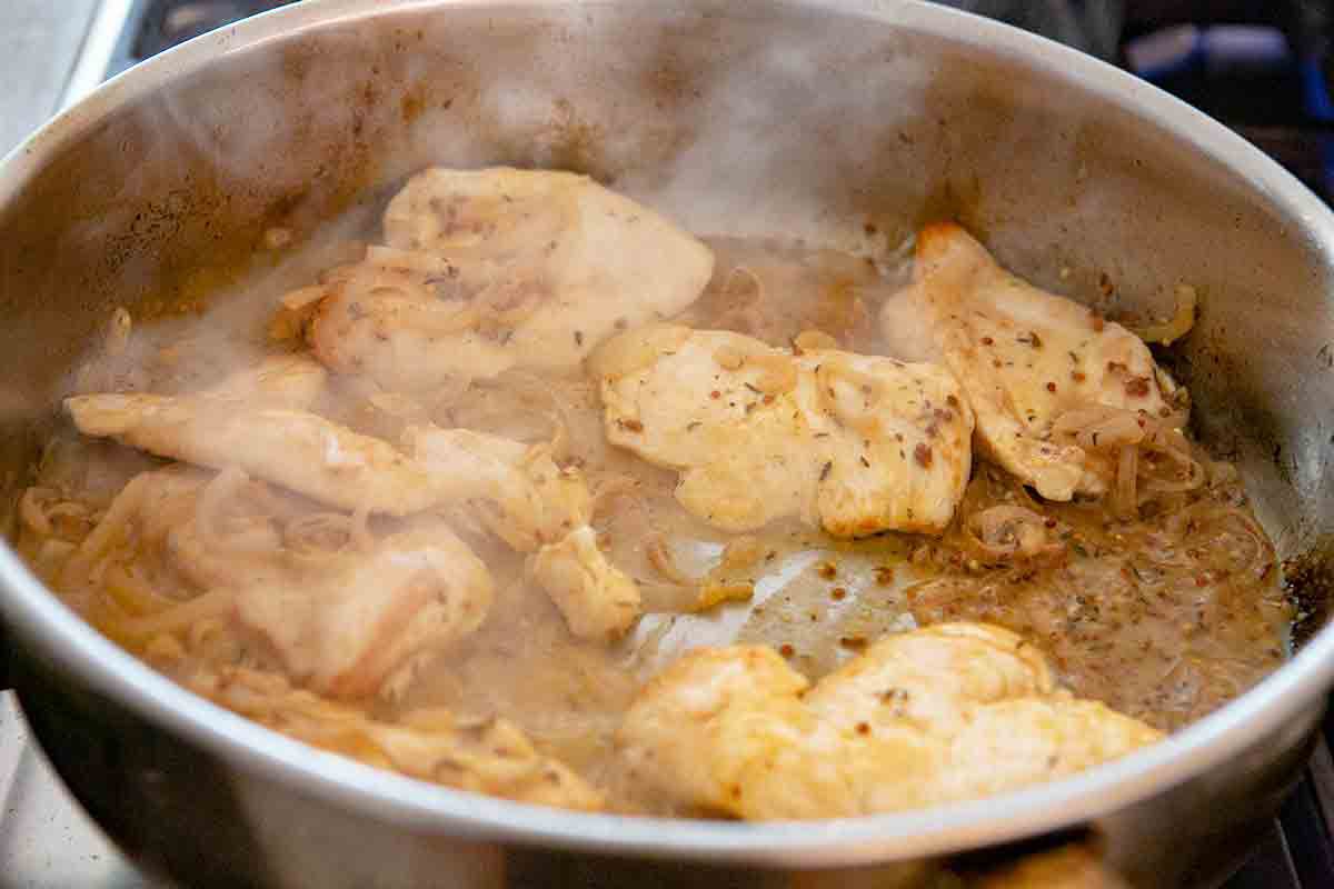 chicken being cooked in dijon sauce