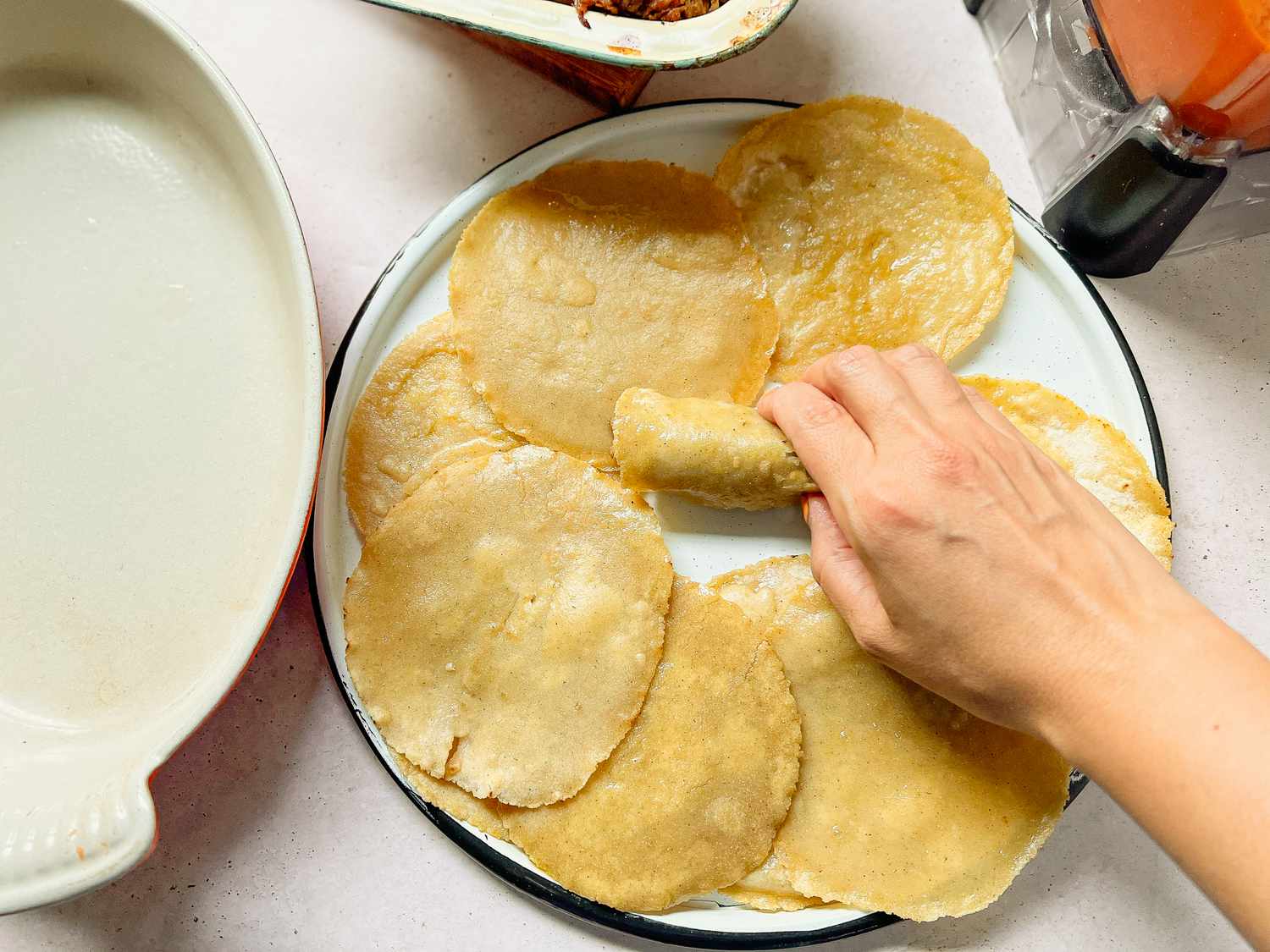 Fried Tortillas on a Plate with One Wrapped Like a Taquito 