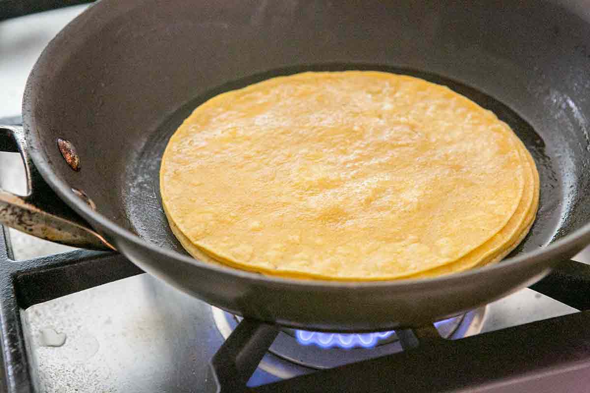Preparing tortillas for easy chicken enchiladas