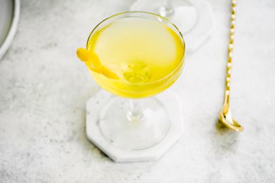 White Negroni Garnished with a Lemon Peel 