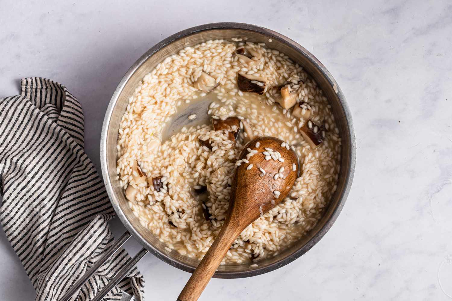 Stirring a pot of mushroom risotto.