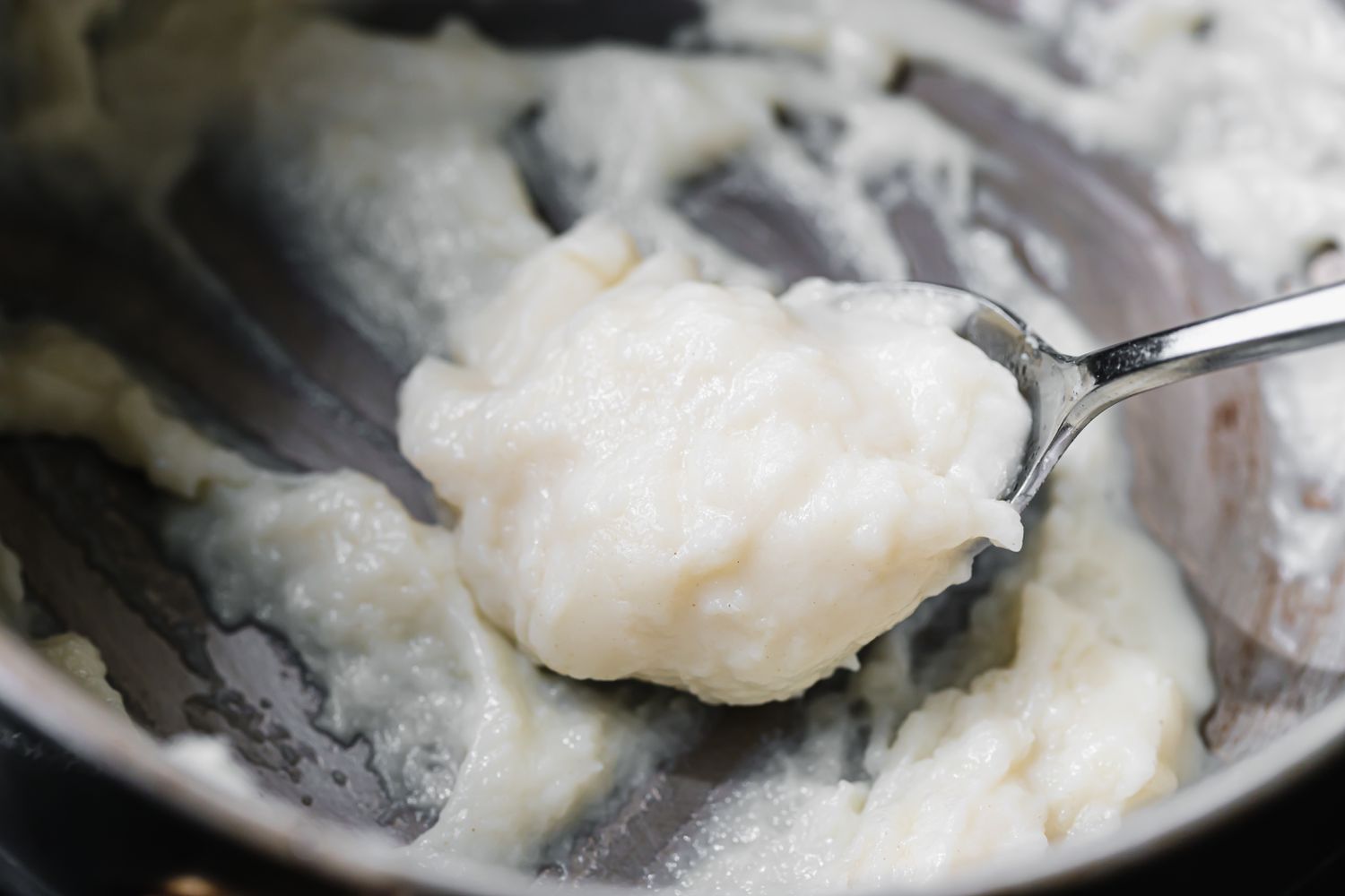 Scooping tangzhong with a spoon for pull apart rolls.