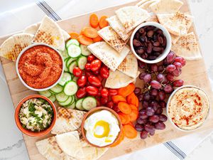 Dips vegetables fruit and olives for mediterranean mezze platter