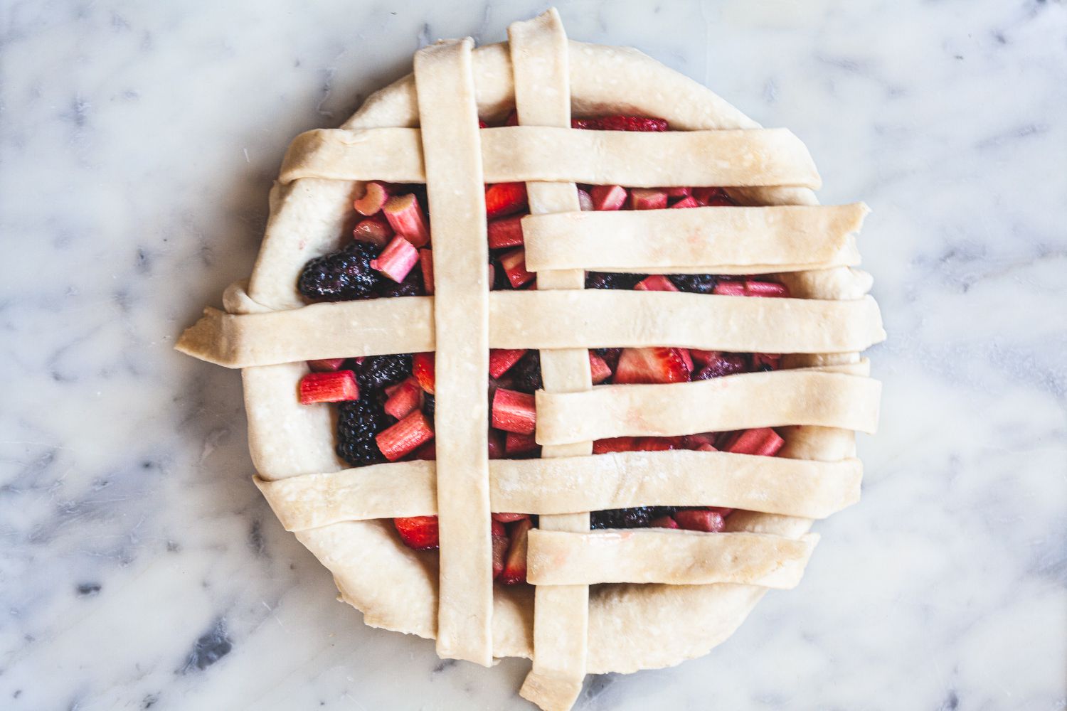 aying strips vertically to show how to make a lattice crust.