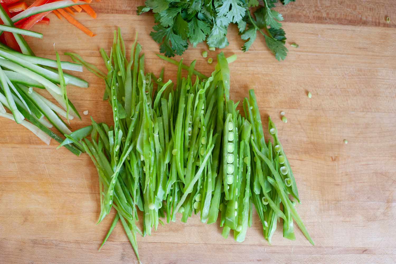 Peas sliced into thin strips to make a vegetable rice noodle salad.