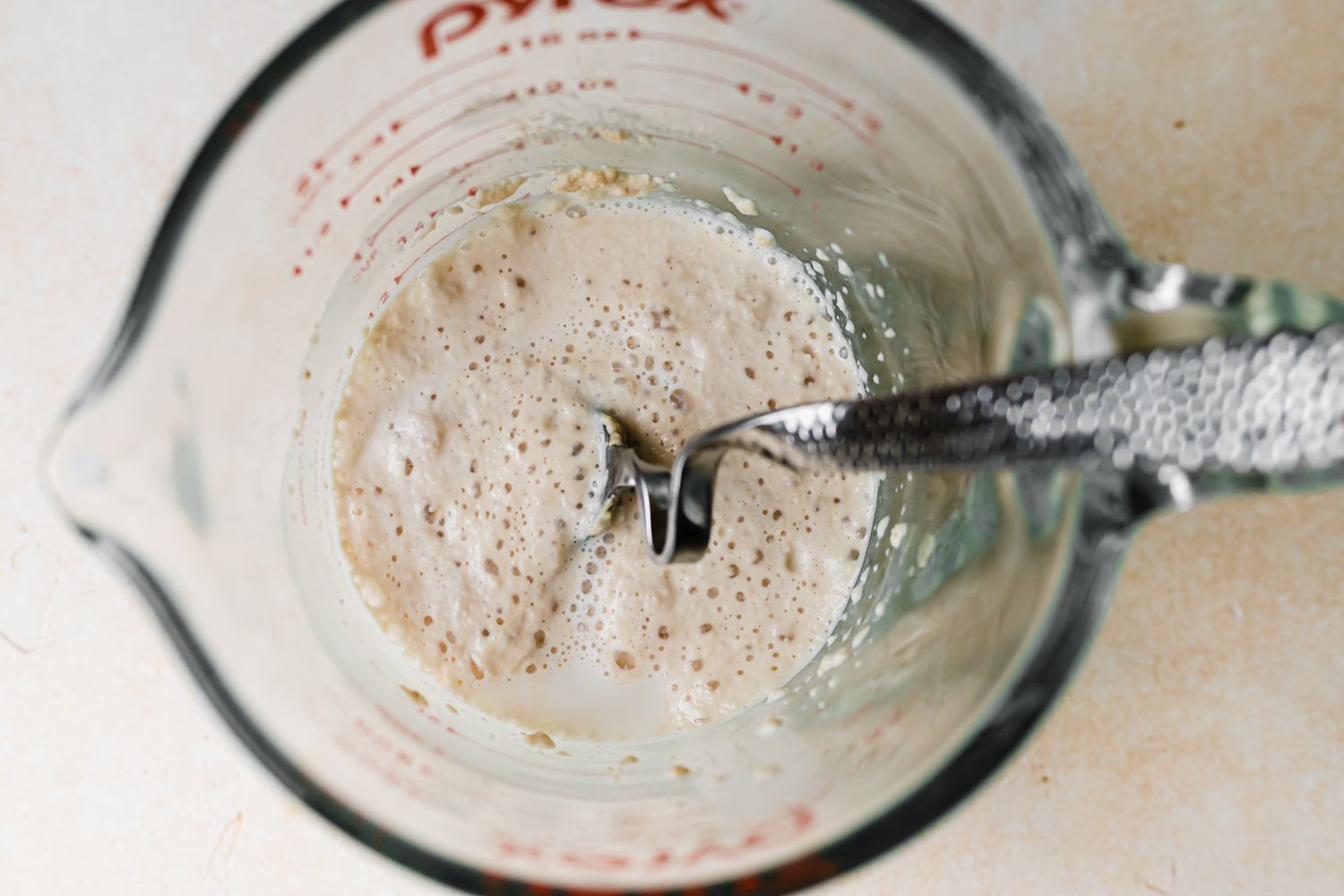Proofing yeast in a liquid measuring cup to make pull apart rolls.