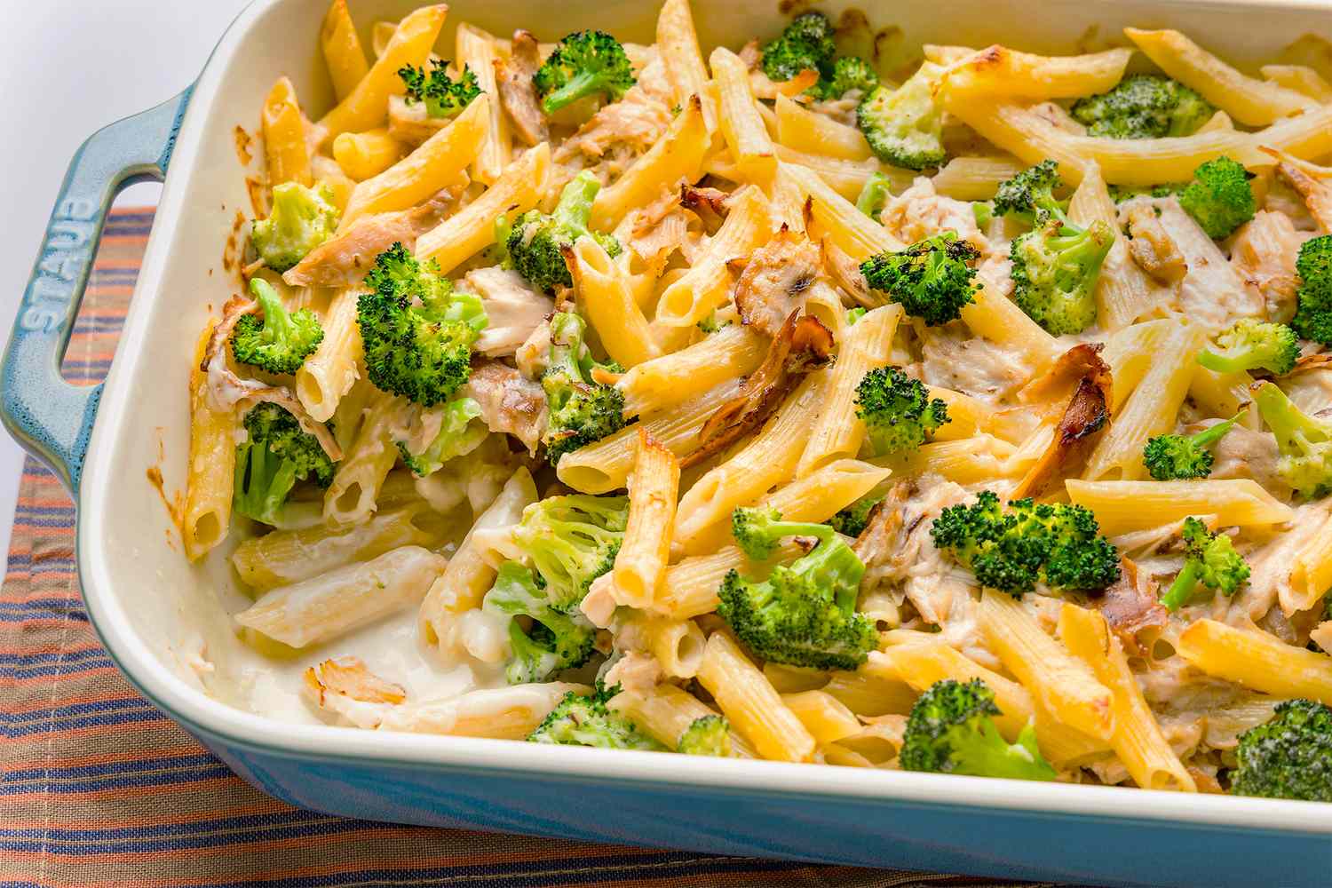 Chicken Alfredo pasta bake with broccoli in a casserole dish