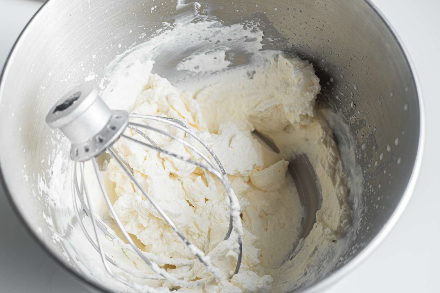 Whipped Cream for Pistachio Cardamom Tres Leches Cake in a Mixing Bowl