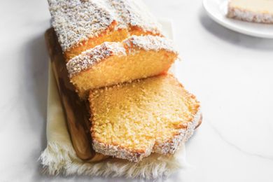 Coconut Pound Cake on cutting board, sliced.