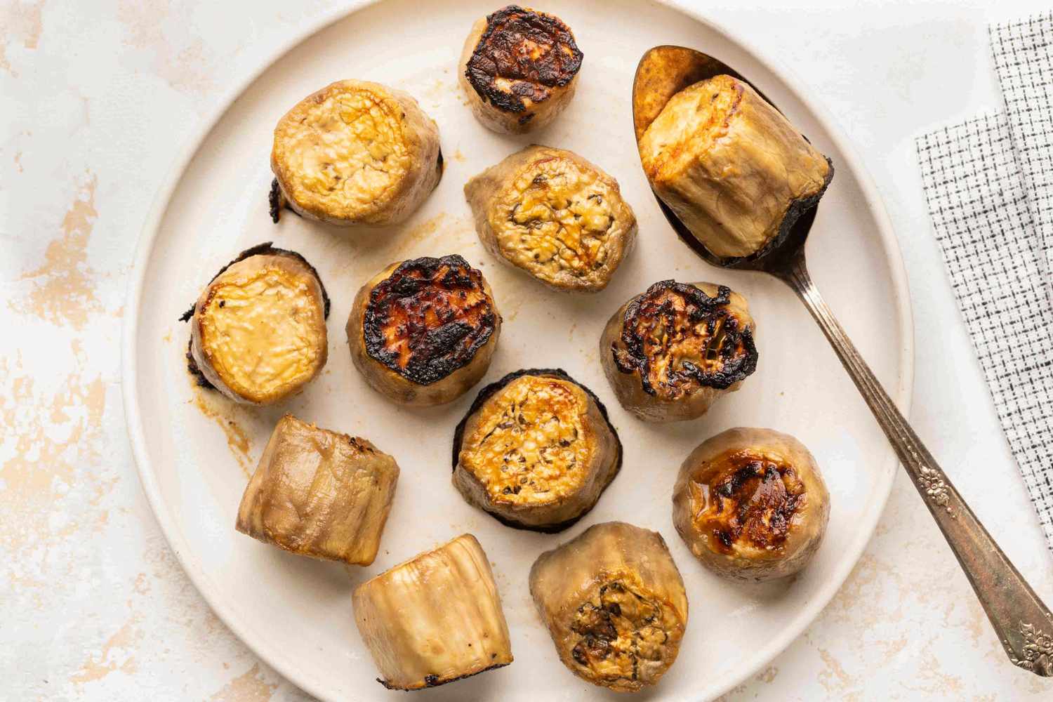 Miso-Glazed Eggplant pieces on a plate with a spoon