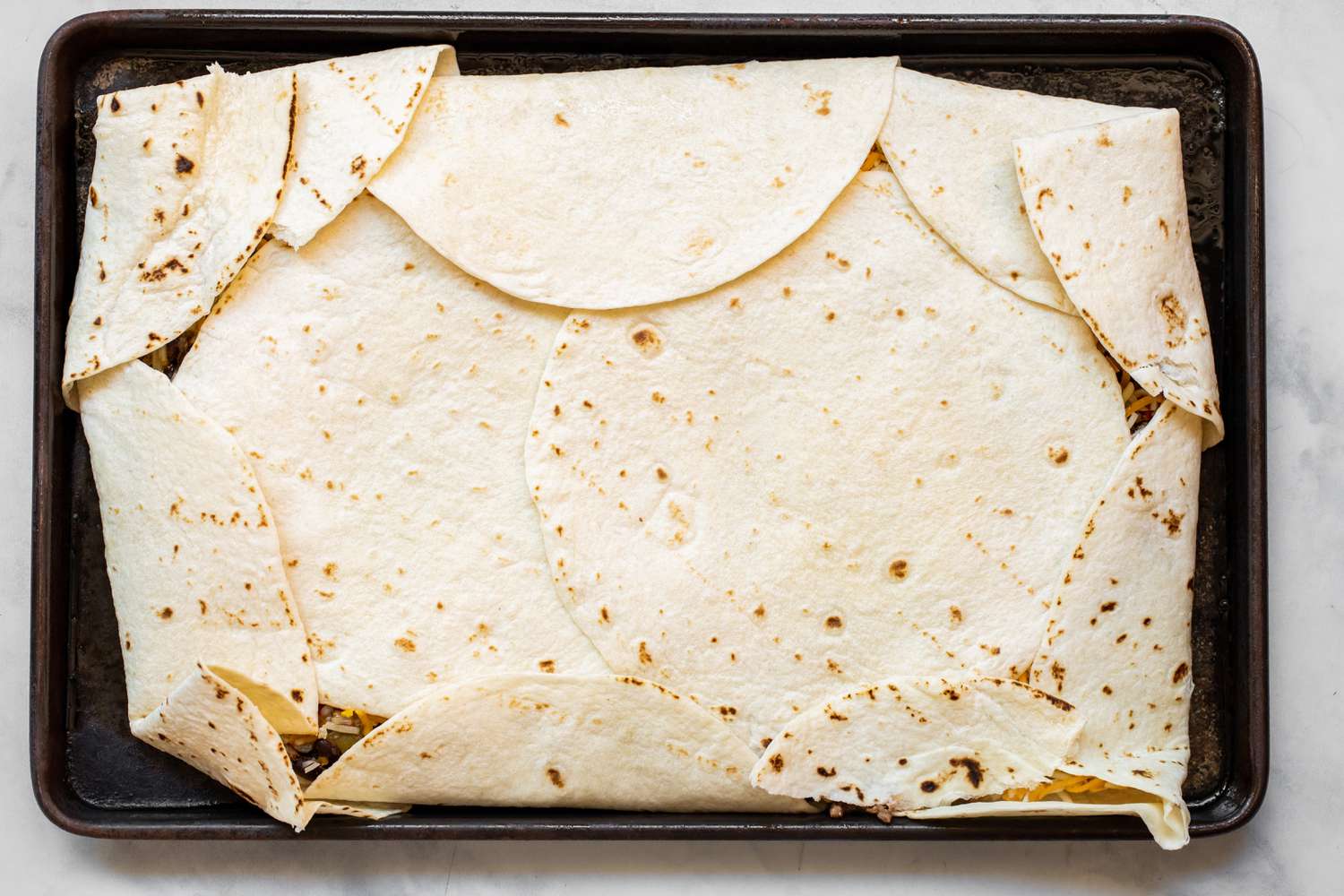 Tortillas Folded onto and Covering the Filling 