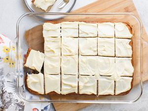 Banana Sheet Cake Frosted and Cut into Portions in a Glass Baking Dish