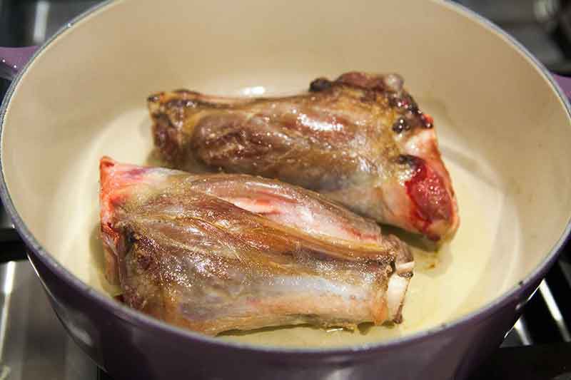 Browning lamb shank in dutch oven pot