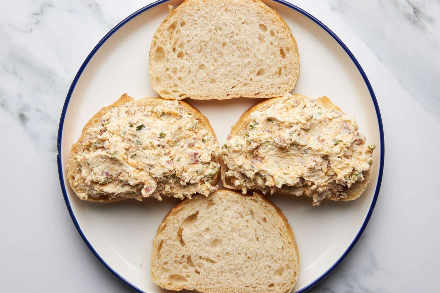 Assemble the sandwich: JalapeÃ±o popper grilled cheese filling added to two slices of bread (non-buttered side)