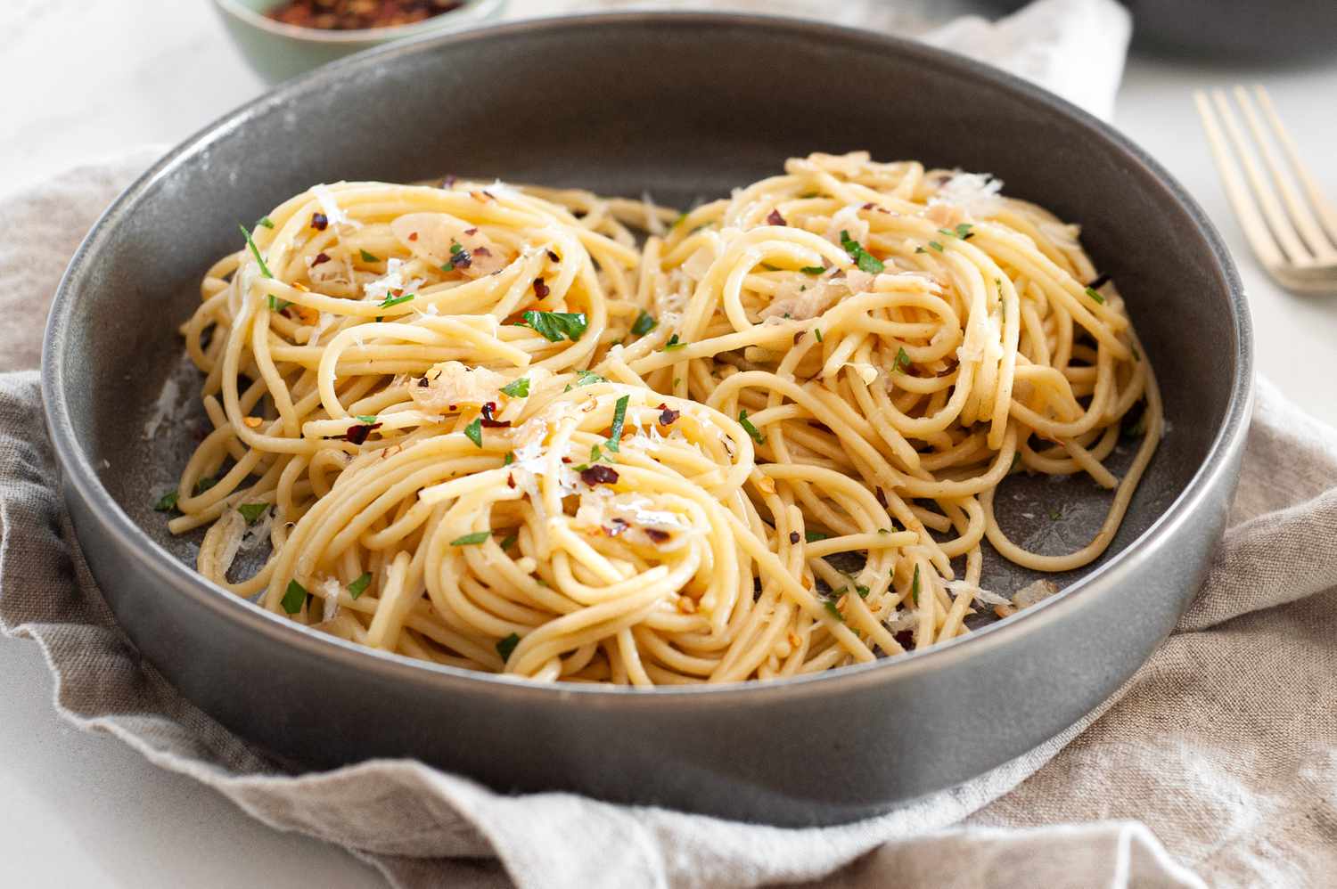 Spaghetti Aglio e Olio (Pasta With Garlic and Oil) Topped with Parsley and Parmesan