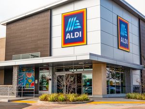 The entrance of an Aldi grocery store with large logo signage on the building
