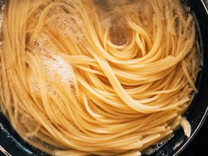 Spaghetti boiling in a pot of water