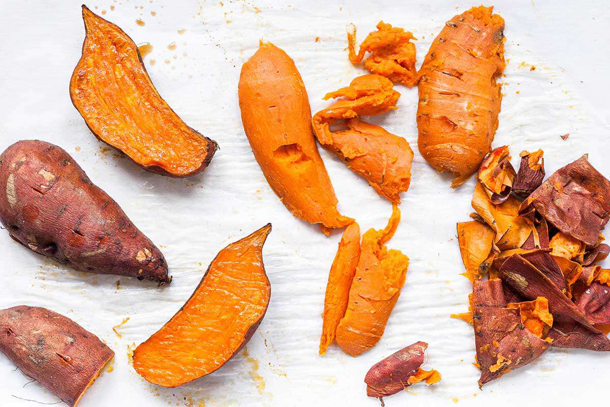 Sweet potatoes sliced open and roasted to make sweet potato pie.