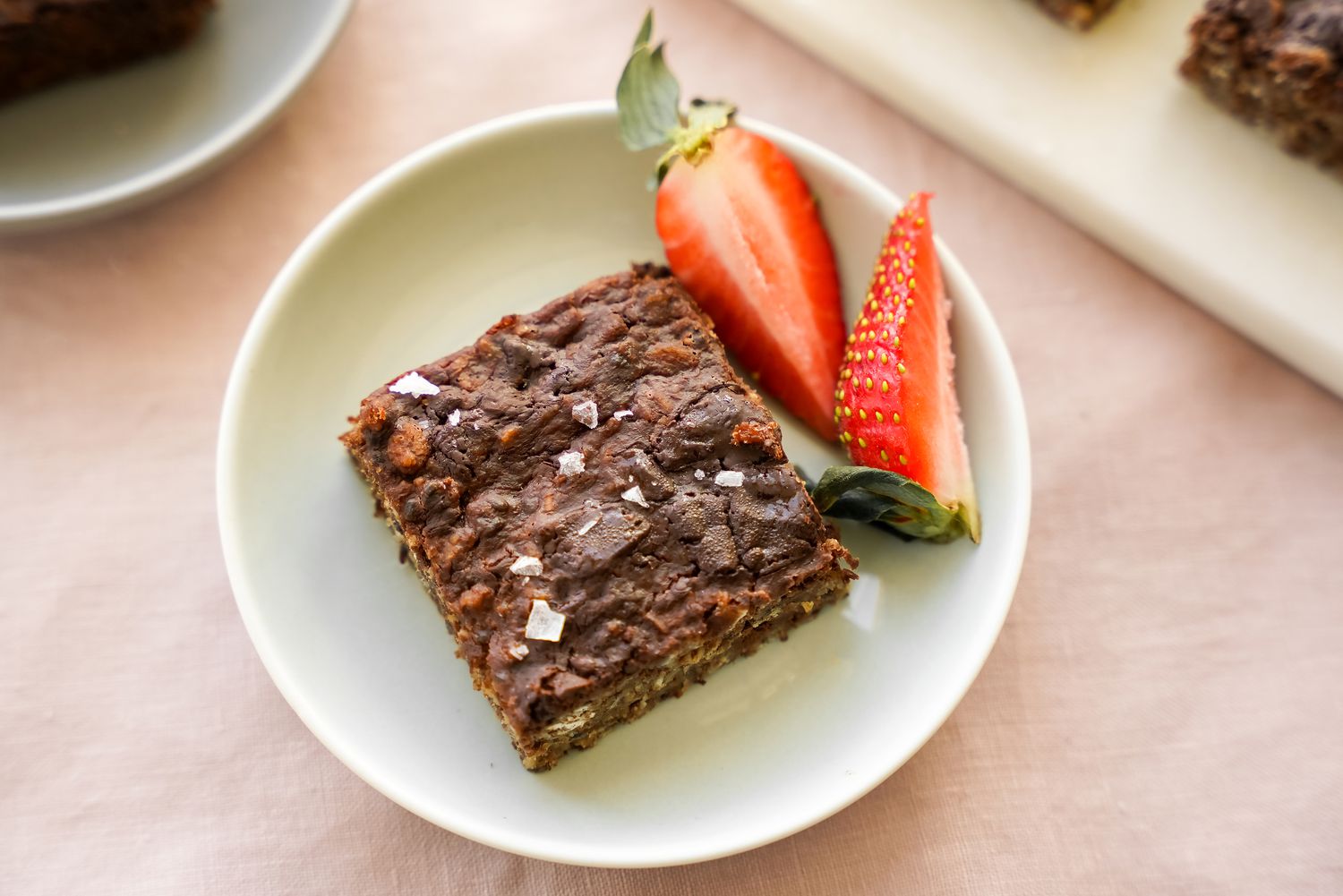 Vegan Brownie Baked Oatmeal on a Small Plate with Quartered Strawberries