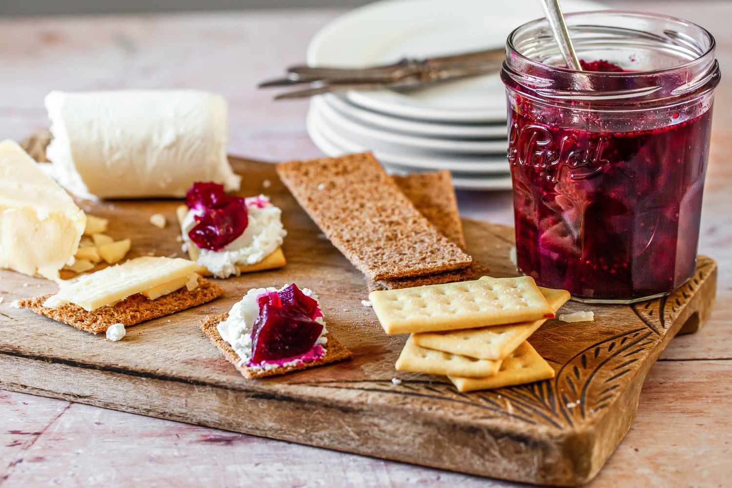 Jar of Beet Chutney on a Charcuterie Board with Cheese and Crackers