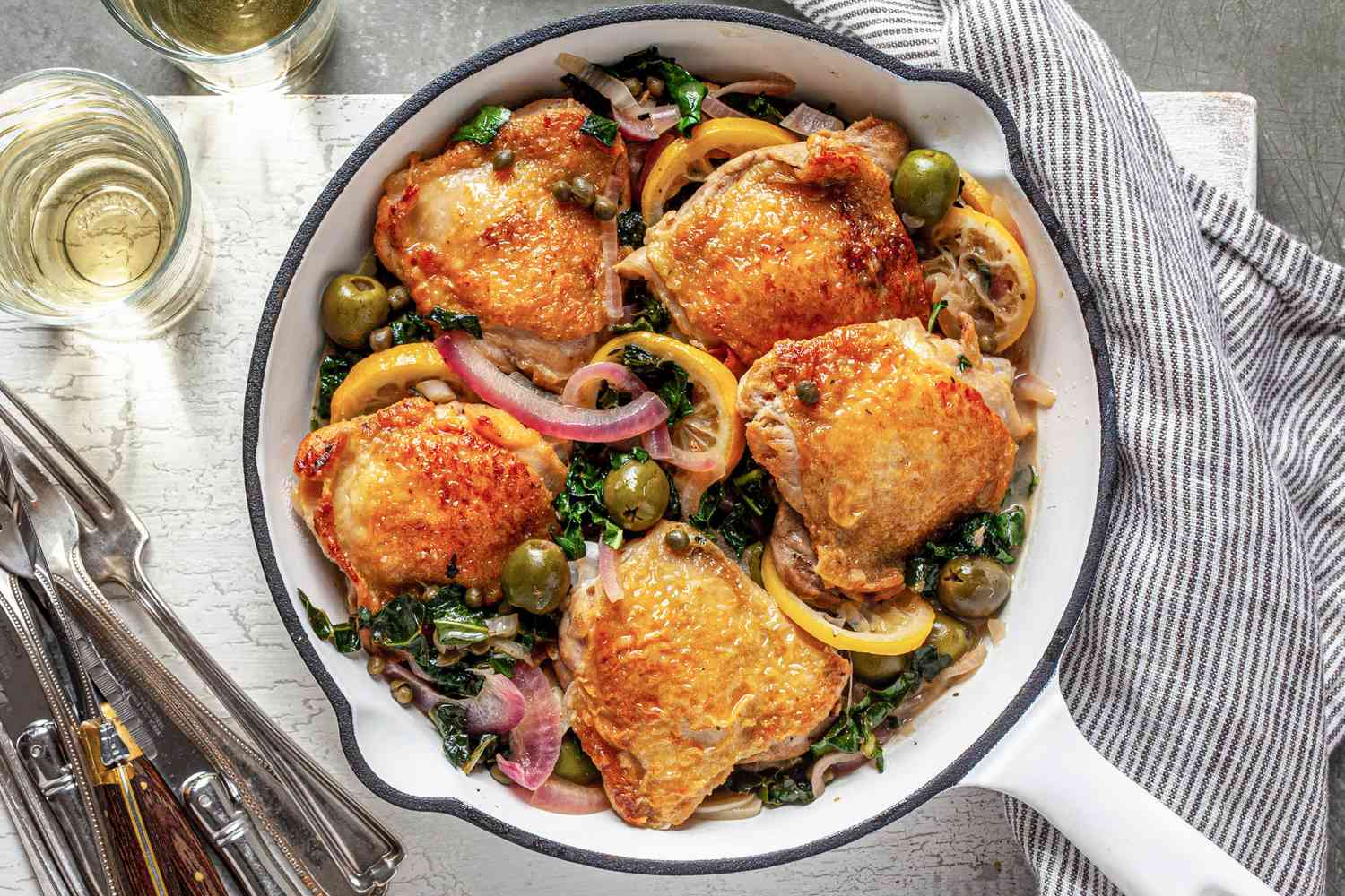 Sicilian chicken in skillet with olives, lemons, and capers.