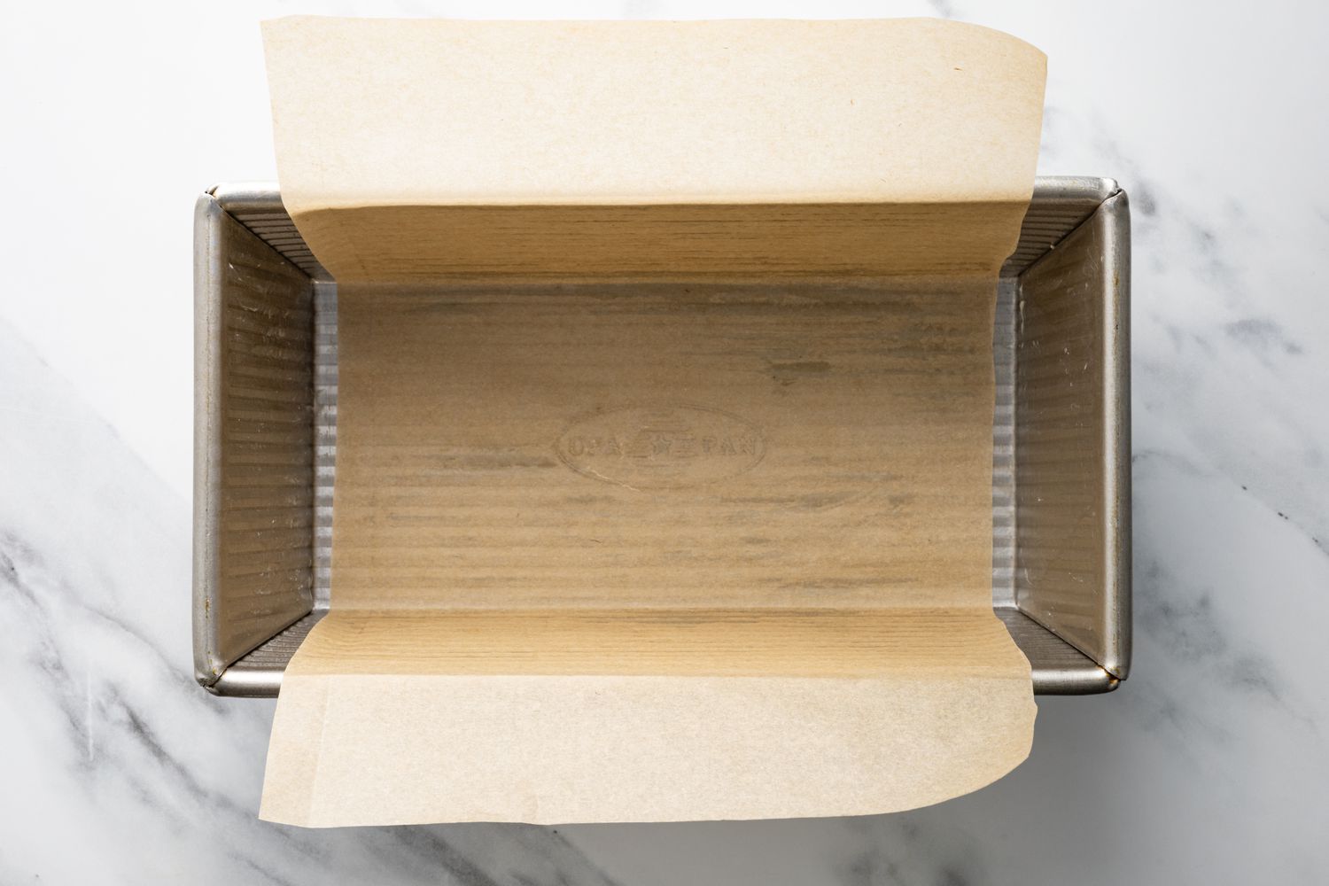 A loaf pan lined with parchment paper
