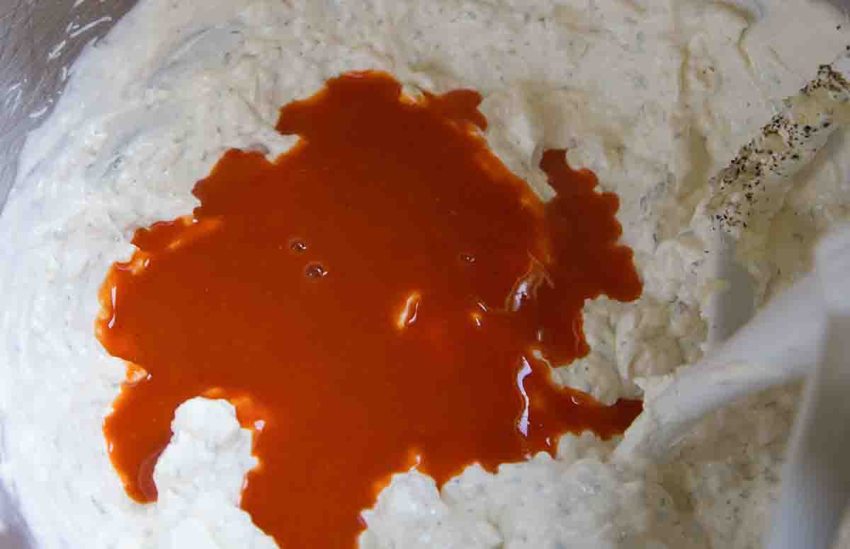 how to make buffalo chicken dip - adding hot sauce