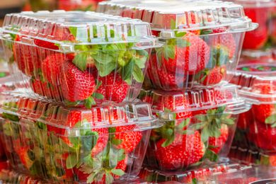 plastic containers of strawberries stacked up