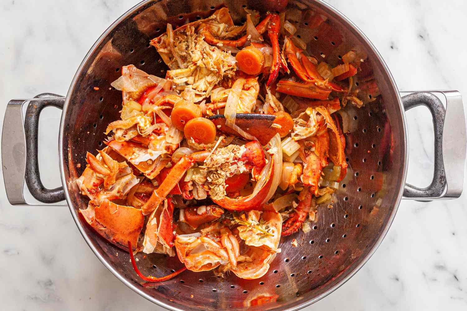 Lobster Bisque Broth Strained Using a Colander