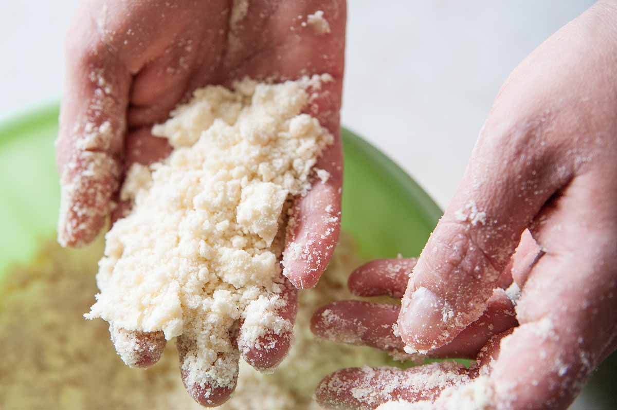 Easy Lemon Bars - hands holding shortbread mixture